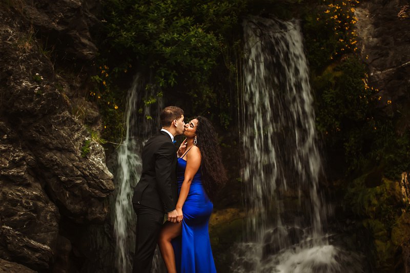 Wedding Photography, couple kissing in front of a waterfall